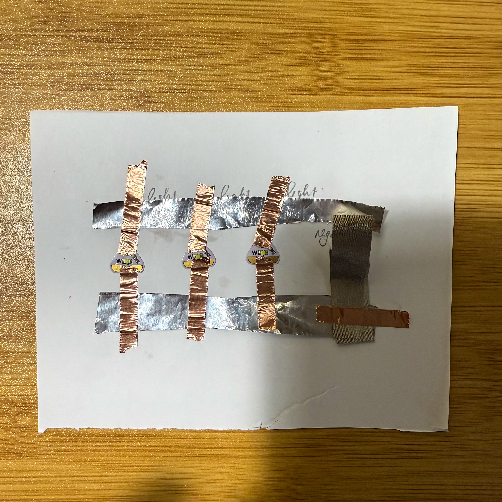 Using the conductive fabric as a button which connects the battery to the circuit and ready to test.