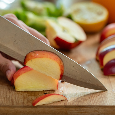 The crisp, satisfying crunch of an apple being sliced with a knife.