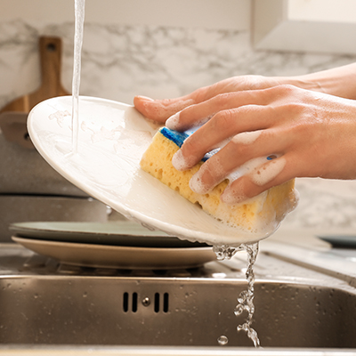 The sound of running water, clinking dishes, and scrubbing.