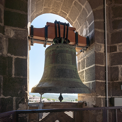 A deep, resonant toll of a church bell echoing through the neighborhood.